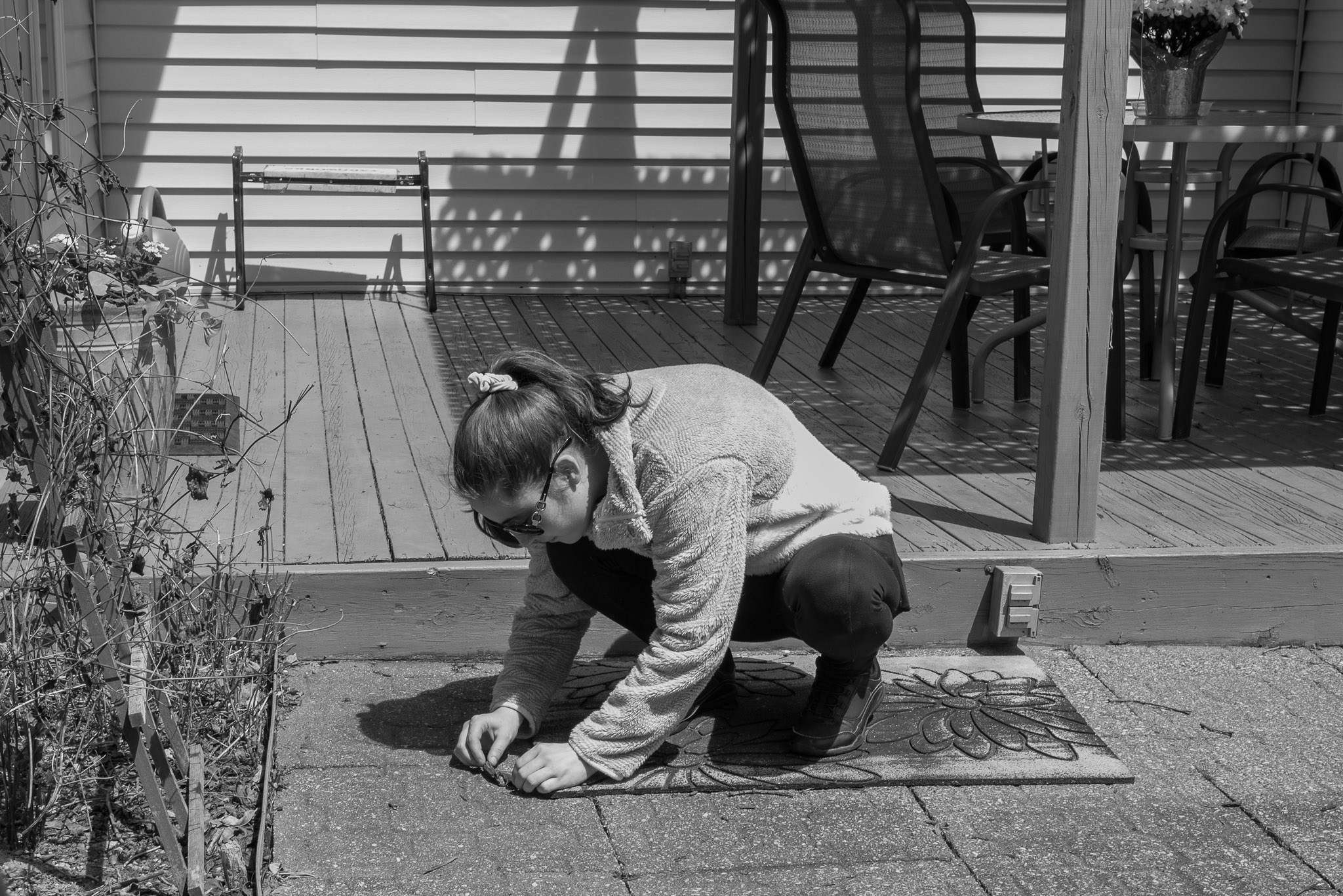 Kelly rescuing a worm. Leica Q2 Monochrom